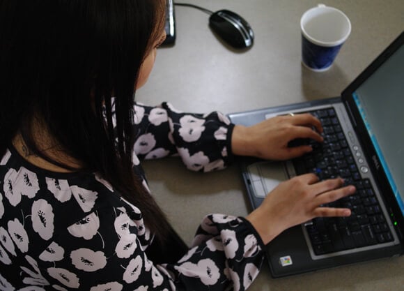 Person sitting at a laptop typing