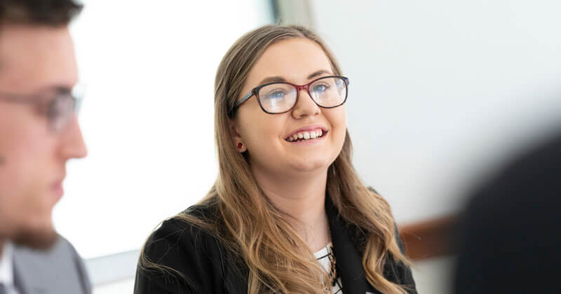 A law student talks with lawyers during a gateway to practice event