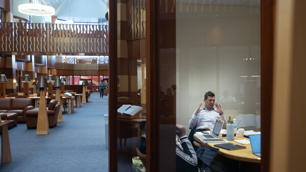 Student sits in a breakout and study room in the School of Law