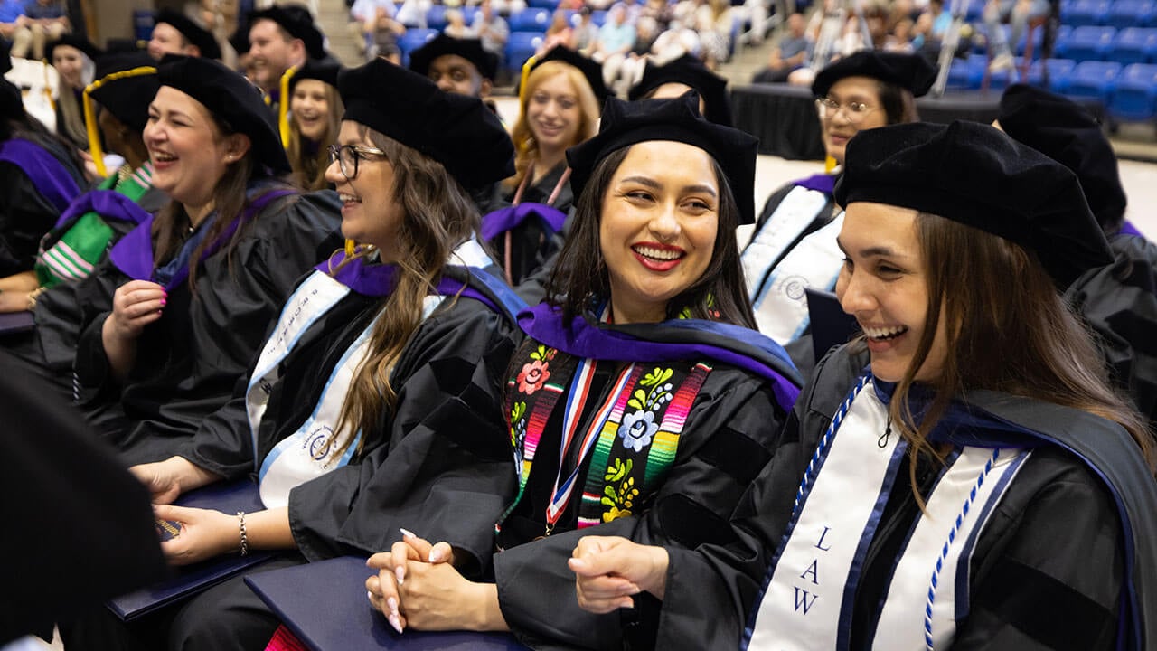 Law graduates laughing and smiling