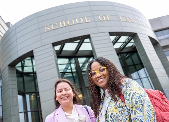 Two students standing in front of the Law School entrance