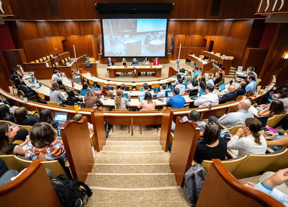 Students and sol professors sitting in ceremonial court room