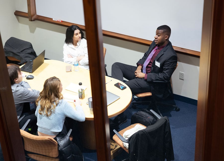 Law students discuss in a study room.
