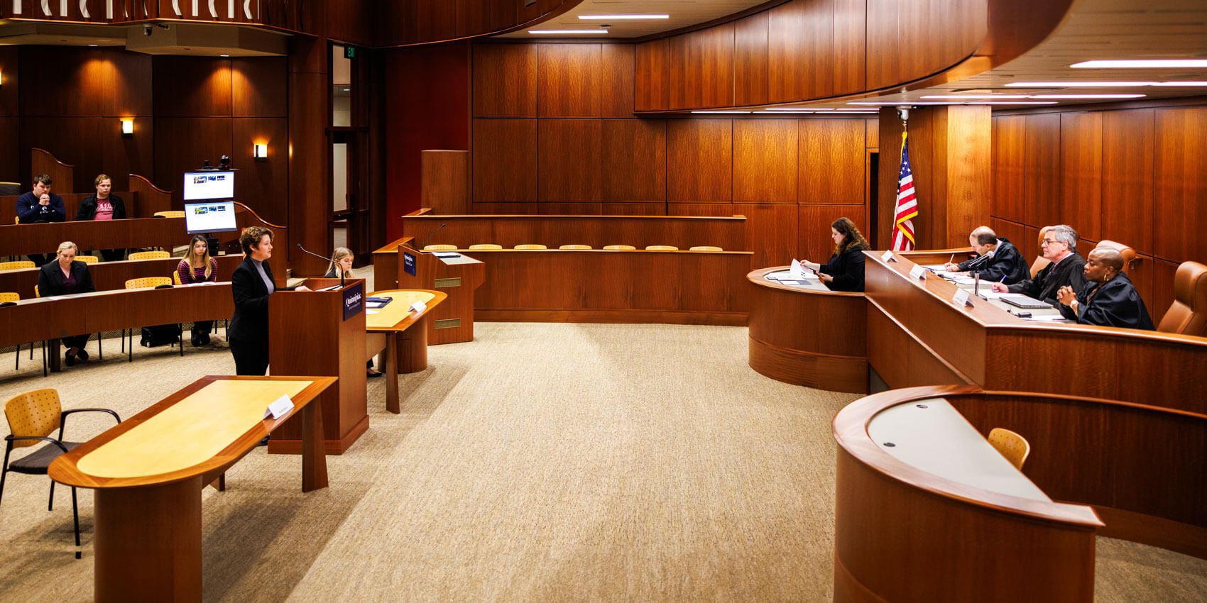 A Quinnipiac Law student participates in a mock trial in the North Haven Campus Ceremonial Courtroom.