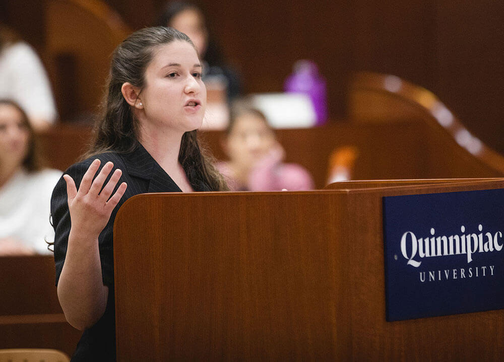 A law student pleads her case from behind a Quinnipiac University lectern in the ceremonial courtroom