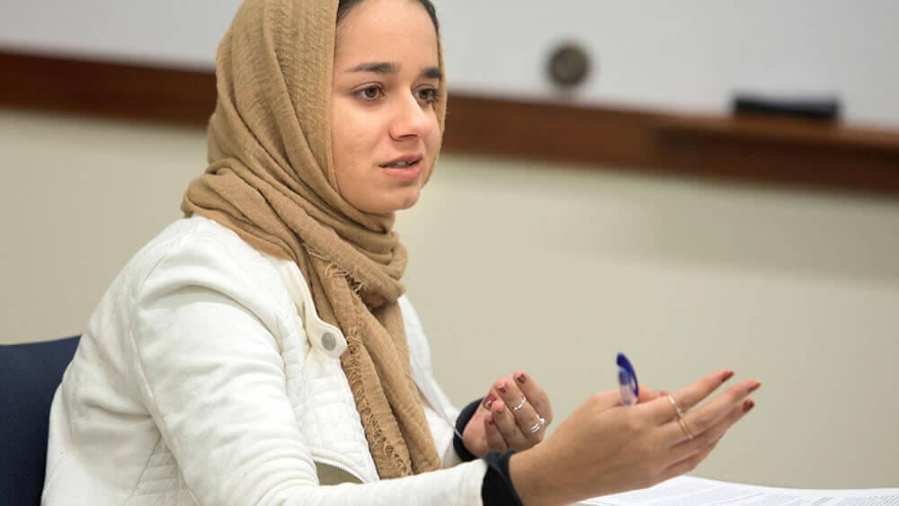 Law student Amina Seval gestures toward a classmate while participating in a workshop