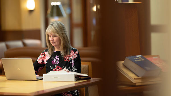 A law student studies in the School of Law library