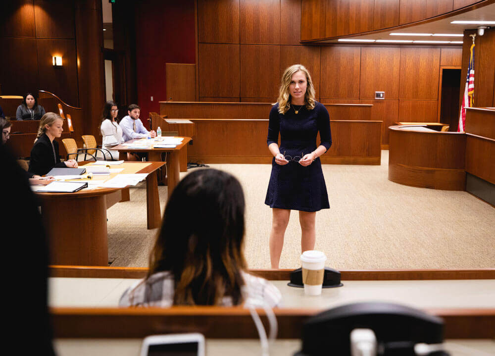 Caitlin Murphy in a mock courtroom, speaking to a mock jury